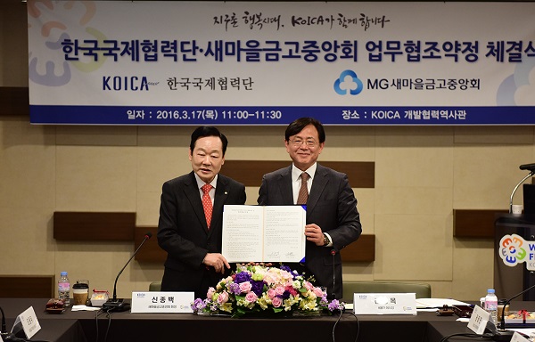△신종백 새마을금고중앙회장(왼쪽)과 김영목 코이카 이사장이 MOU체결 협약서를 함께 들고 있다./사진제공=새마을금고중앙회
