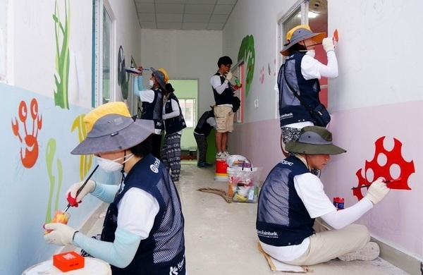 효성과 한국수출입은행 임직원들이 신축되는 흡픅 유치원 복도 벽에 그림을 그리고 있다. 효성 제공