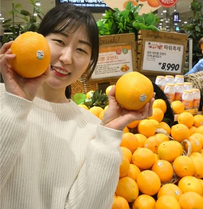 23일 파워축제가 열린 서울 킴스클럽 NC강서점에서 모델이 점보오렌지를 선보이고 있다.