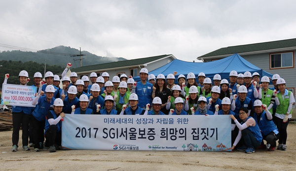 △SGI서울보증이 춘천의 해비타트 건축현장을 찾아 소외계층 어린이들의 주거환경 개선을 위한 후원금 1억원을 전달하고 희망의 집짓기 봉사활동을 실시했다./ 사진제공=SGI서울보증