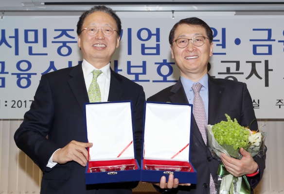 14일 서울 여의도 금융감독원에서 열린 ‘2017 서민·중소기업지원, 금융사기 근절 및 금융소비자보호 유공자 시상식’에서 위성호 신한은행장(오른쪽)이 금융소비자보호·서민금융·중소기업지원 3개 부문 ‘최우수 금융기관’ 수상 후 최흥식 금융감독원장(왼쪽)과 기념촬영 하고 있다. / 사진제공= 신한은행