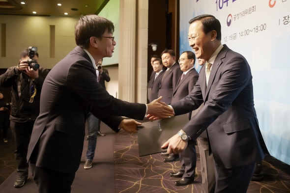 15일 서울 양재동 엘타워에서 김도진 기업은행장(사진 오른쪽)이 김상조 공정거래위원장(사진 왼쪽)으로부터 CCM 인증서를 받고 있는 모습. / 사진제공= 기업은행