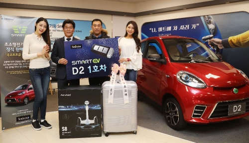 27일 오전 이마트 성수점에서 열린 초소형 전기차 D2 고객 인도 기념행사에서 이순종 쎄미시스코 대표(좌측에서 두 번째)가 D2 1호 고객인 이영우(우측에서 두 번째)씨와 기념 촬영을 하고 있다. 이마트 제공