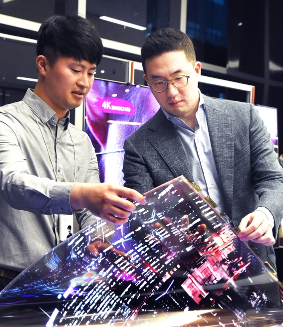 ▲ 지난달 12일 구광모 회장이 서울시 강서구 마곡 LG사이언스파크를 방문해 연구원과 함께 ‘투명 플렉시블 OLED’를 살펴보고 있다.