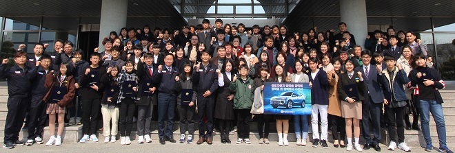 쌍용차 한마음 장학회 관계자들과 장학생 및 가족들이 쌍용자동차 본사 건물 앞에서 기념촬영을 하고 있다. (사진=쌍용차)