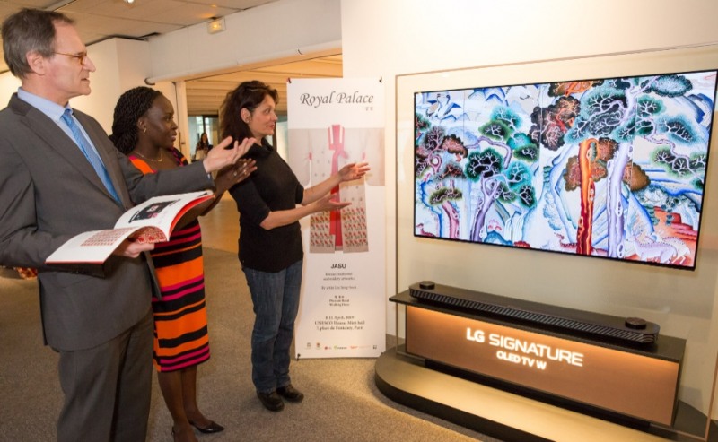 △파리 유네스코본부 전시장에서 관람객들이 올레드 TV에 보이는 궁중자수 작품을 관람하고 있다/사진=LG전자