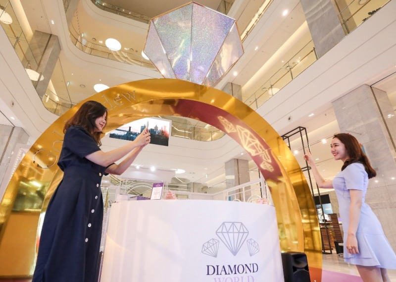 25일 오전 현대백화점 판교점 1층 열린광장에서 고객들이 4M 높이의 다이아몬드 반지 모형이 설치된 '골든듀 다이아몬드 월드' 팝업스토어를 구경하고 있다. /사진제공=현대백화점