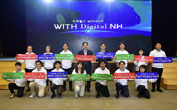 ▲ 지난 4월 19일 농협중앙회 대강당에서 이대훈 은행장(가운데 빨간 플랜카드)과 남영수 디지털금융부문 부행장(가운데 파란 플랜카드)이 ‘디지털 트랜스포메이션’ 선포식을 가진 후 기념촬영을 하고 있다. 사진 = NH농협은행