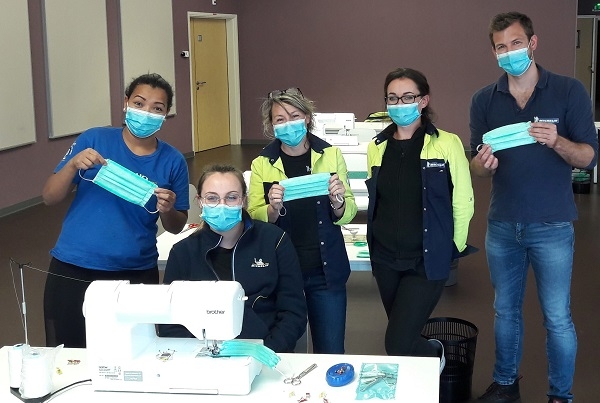 미쉐린 직원들이 자체 제작한 의료용 마스크를 들고 기념촬영을 하고 있다. 사진=미쉐린그룹.