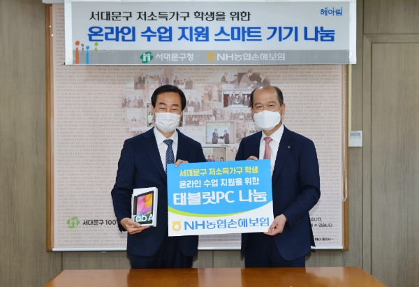 NH농협손해보험은 서울 서대문구청을 찾아 저소득가구 학생들을 지원할 태블릿PC 100대를 지난 13일 전달했다. 태블릿PC 전달 후 최창수 대표이사(오른쪽)와 문석진 서대문구청장(왼쪽)이 기념사진 촬영을 하고 있다. / 사진 = NH농협손해보험
