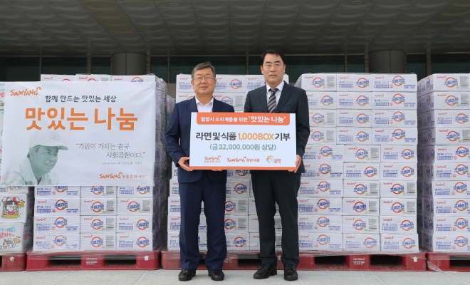 삼양식품 진종기 대표이사(오른쪽)가 박일호 밀양시장에게 후원물품을 전달하고 있다. 사진 = 삼양식품