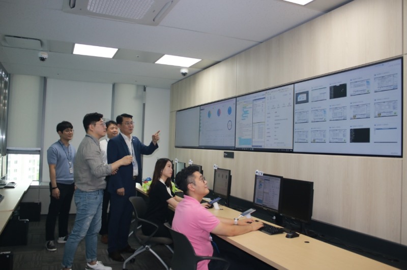 위길량 IT디지털금융부장(왼쪽 네번째)과 RPA담당자들이 RPA Lab. 에서 로봇 모니터링을 하고 있다. /사진=NH농협은행