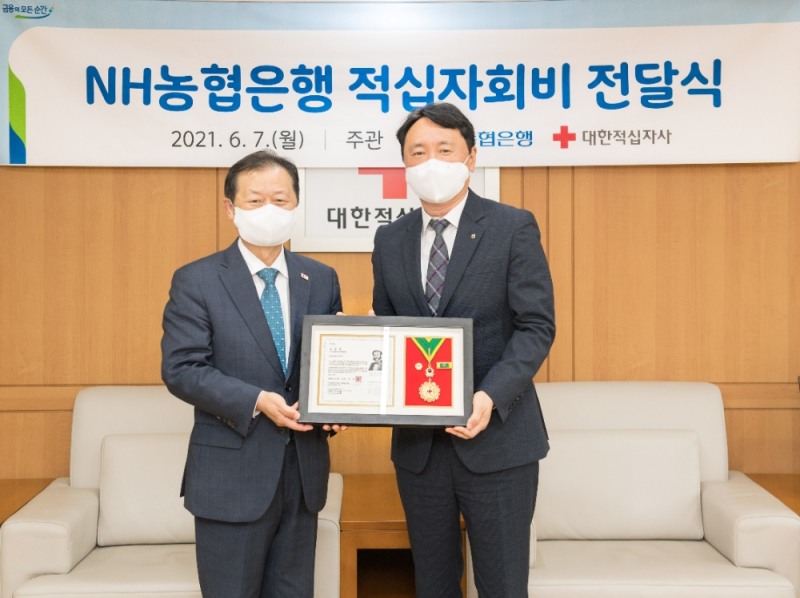 권준학 NH농협은행장(오른쪽)과 신희영 대한적십자사 회장이 지난 7일 서울 중구 대한적십자 본사에서 대한적십자 회비 2억원 전달식을 가진 뒤 기념촬영을 하고 있다./사진=NH농협은행