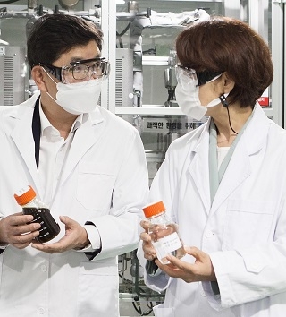 나경수 SK종합화학 사장(왼쪽)이 한정애 환경부 장관에게 폐플라스틱 열분해유 시제품을 소개하고 있다. 사진=SK이노베이션.