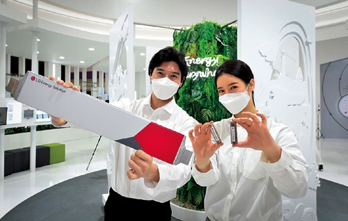 ▲ LG에너지솔루션 직원들이 파우치 배터리(왼쪽)과 원통형 배터리를 소개하고 있다.