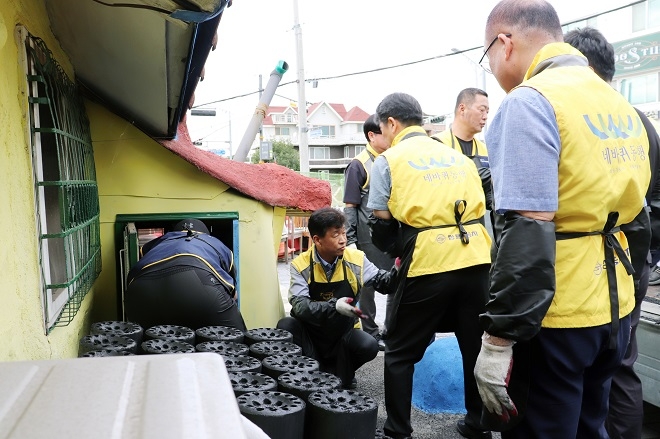 KG모빌리티 임직원들이 2023평택연탄나눔 발대식에 참석한 뒤 연탄 배달 활동을 하고 있다. 사진제공=KG모빌리티.
