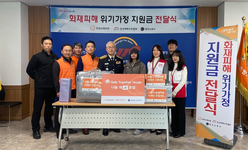 한화손해보험 봉사단이 장형순(사진 가운데) 광진소방서장과 함께 서울시 화재피해가정에 위로금과 구호키트를 전달하고 있다. 사진 제공=한화손해보험