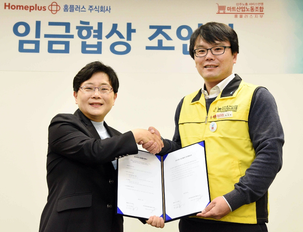 임일순 홈플러스 대표이사 사장(왼쪽)과 주재현 마트산업노동조합 홈플러스지부 위원장(오른쪽)이 지난 18일 서울 강서구 홈플러스 본사에서 2019년 임금협약 조인식을 마친 후 협약서를 함께 들어 보이며 악수를 나누고 있다. /사진제공=홈플러스