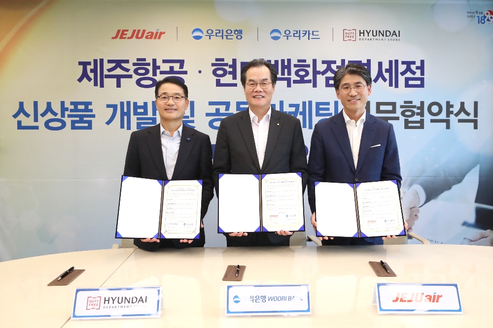 우리은행은 12일 서울시 중구에 위치한 본점에서 우리카드, 제주항공, 현대백화점면세점과 함께 ‘신상품 개발 및 공동마케팅을 위한 업무협약’을 체결했다. 이날 협약식에서 이동연 우리은행 국내부문장(사진 가운데), 황해연 현대백화점면세점 대표이사(왼쪽), 김재천 제주항공 부사장(오른쪽). / 사진= 우리은행