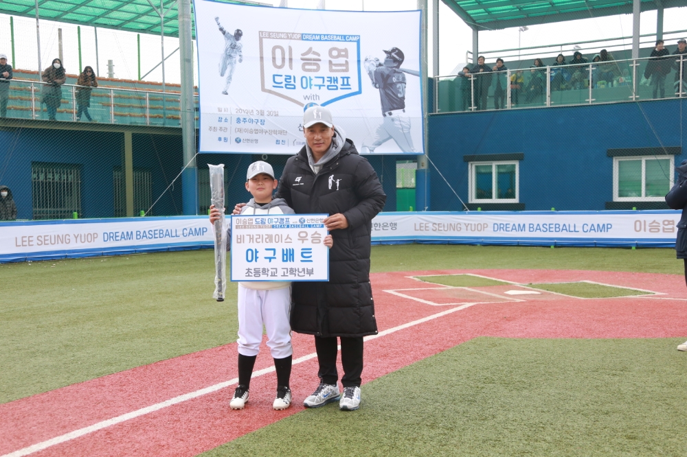 지난 3월 30일 충주 야구장에서 신한은행이 이승엽 야구장학재단과 함께 개최한 ‘이승엽 드림 야구캠프 with 신한은행’에서 이승엽 이사장이 비거리 레이스 프로그램에서 우승한 학생과 함께 기념 촬영하는 모습 / 사진= 신한은행