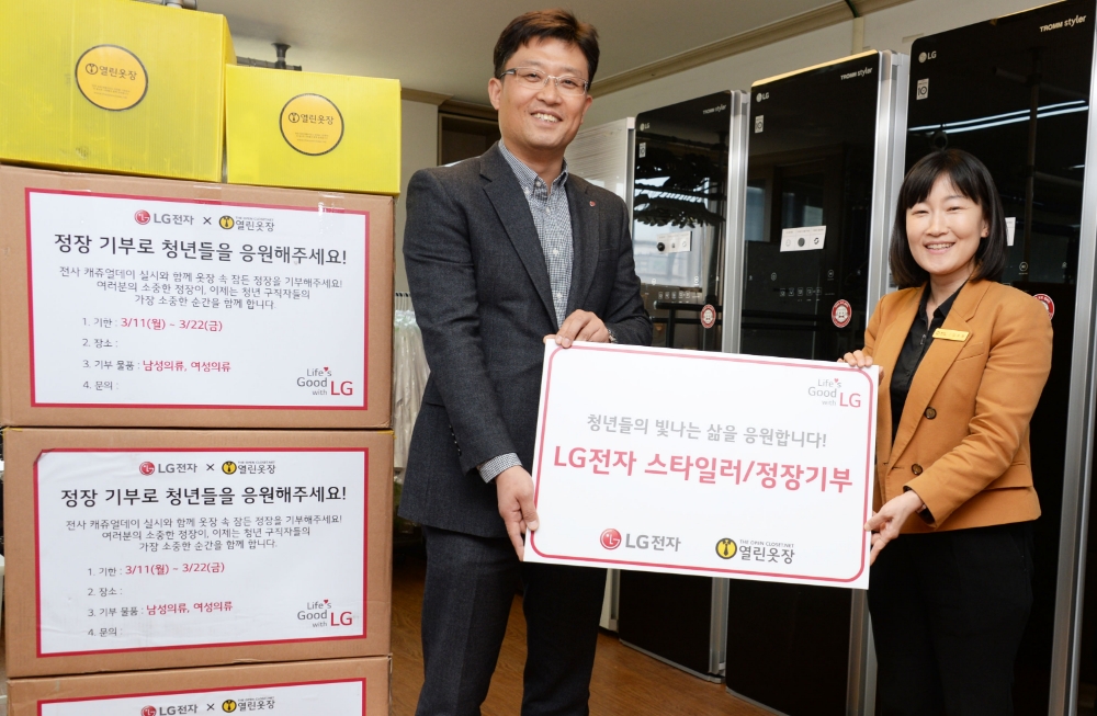 △임정수 LG전자 한국B2B마케팅담당(좌측)이 김소령 열린옷장 대표(우측)에게 정장과 스타일러를 기부하고 있다/사진=LG전자