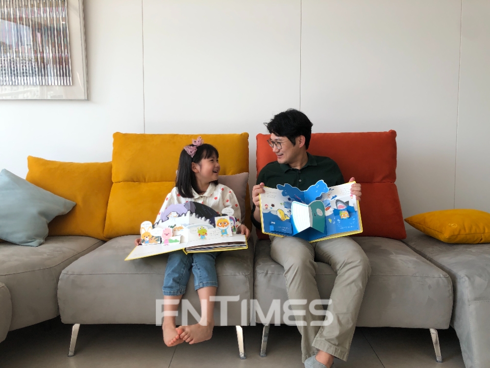 한화건설 직원이 자녀와 함께 복지기관에 전달할 팝업북을 만들고 있다. / 사진제공=한화건설