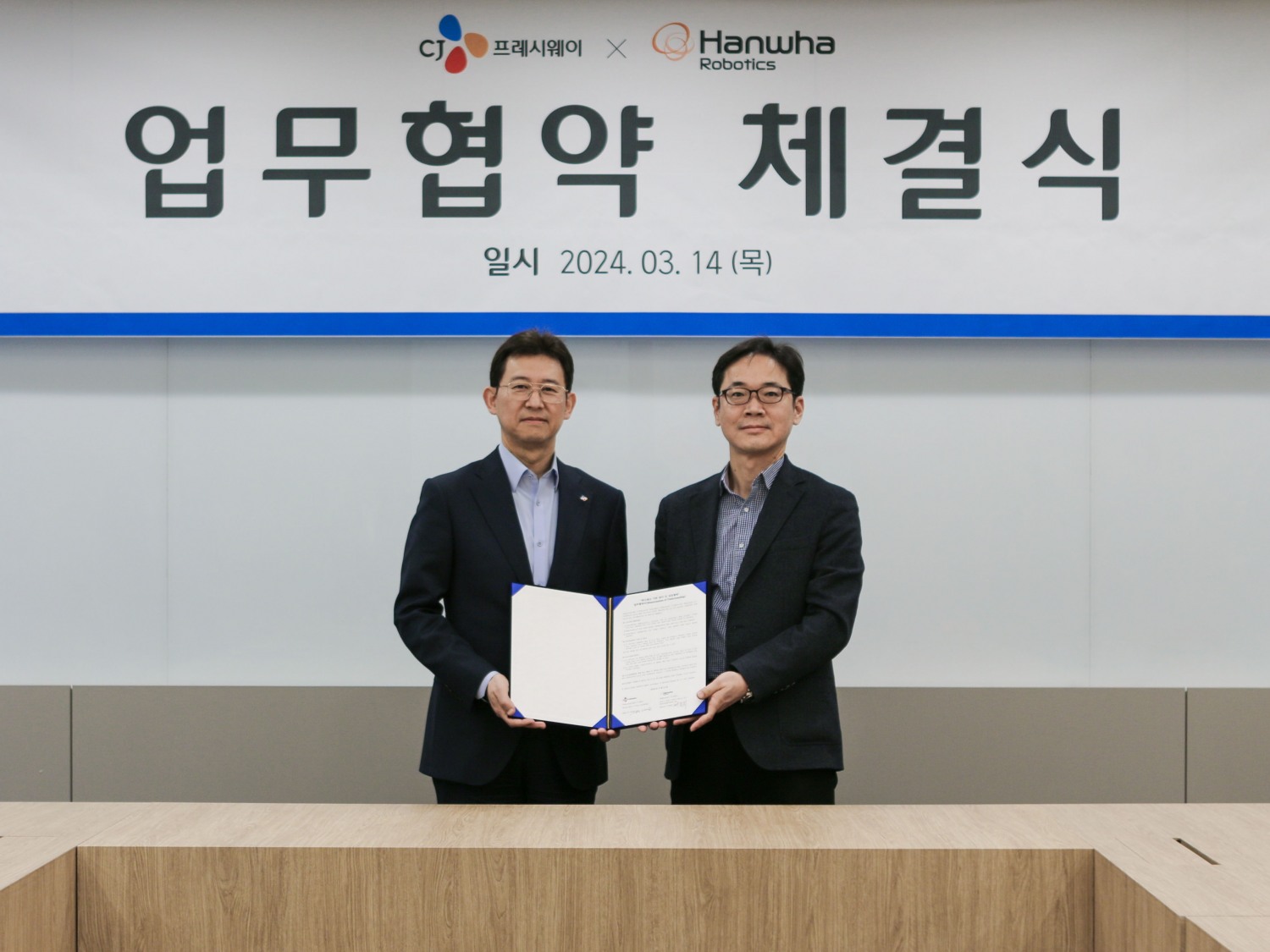 정성필 CJ프레시웨이 대표이사(좌), 서종휘 한화로보틱스 대표이사가 14일 CJ프레시웨이 서울 본사에서 ‘푸드서비스 자동화’ 업무협약(MOU)을 체결했다. /사진제공=한화로보틱스