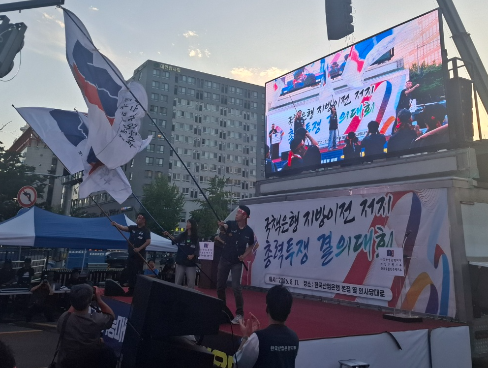 11일 저녁 열린 국책은행 3사 공동집회에서 각 은행 노조 지부장들이 깃발을 흔들어보이고 있다. / 사진=장호성 기자