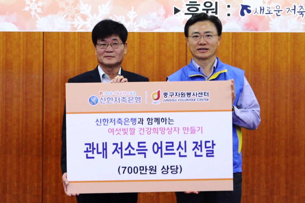 △김영표 신한저축은행 대표(오른쪽)가 봉사활동 수 기념촬영을 하고 있다./사진=신한저축은행