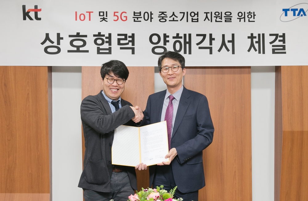 △김근영 KT 컨버전스기획담당 상무(왼쪽)와 박용범 TTA 정보통신시험인증연구소장이 업무협약 체결 행사를 마치고 기념촬영을 하고 있다.