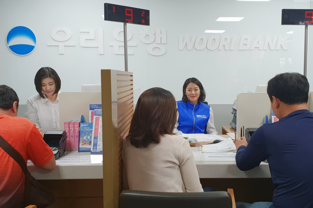 평택외국인일요송금센터에 방문한 외국인 고객의 업무를 처리하고 있는 우리은행 직원 / 사진= 우리은행