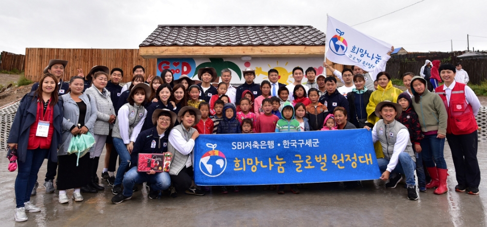 △SBI희망나눔 글로벌 원정대원들이 마을 우물 시설 공사를 마치고 지역 주민들과 함께 밝은 미소를 짓고 있다./사진=SBI저축은행