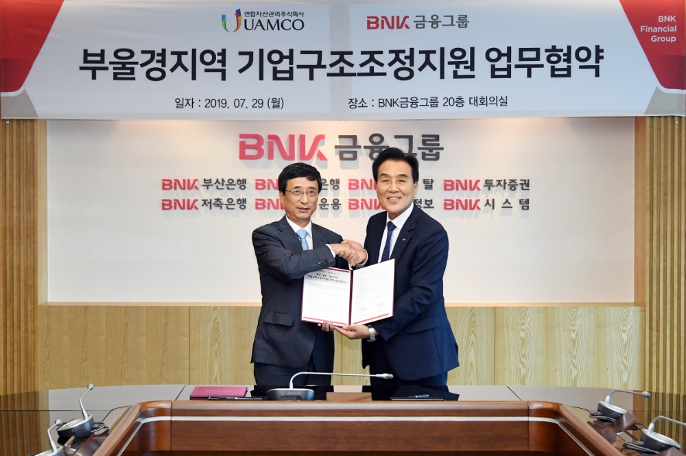 김지완 BNK금융 회장(오른쪽), 김석민 유암코 대표이사가 ‘부울경 지역 기업구조조정지원 업무협약’을 체결 후 기념촬영을 하고 있다./사진=BNK금융