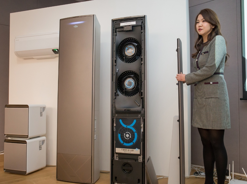 삼성전자 관계자가 삼성 무풍 에어컨의 전면 패널 전체 분리 및 직접 청소 기능을 시연하고 있다/사진=삼성전자