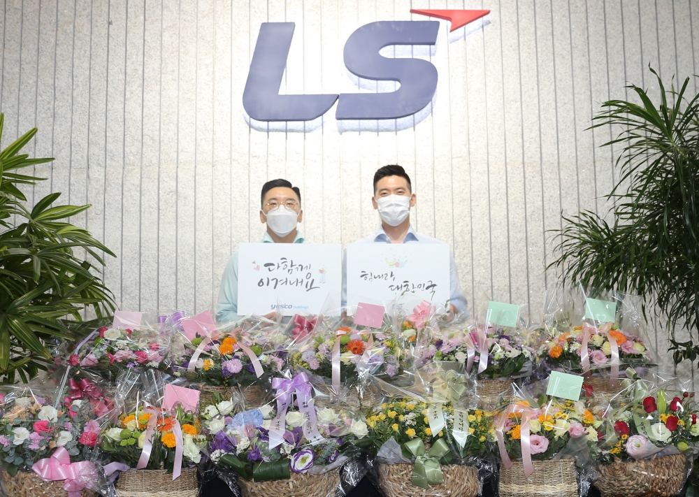 구본혁 예스코홀딩스 부사장(좌)과 구동휘 (주)LS 전무(우)가 7일, '플라워 버킷 챌린지'에 동참하고 '다함께 이겨내요', '힘내라 대한민국' 응원 메세지를 전달하고 있다./사진=LS그룹