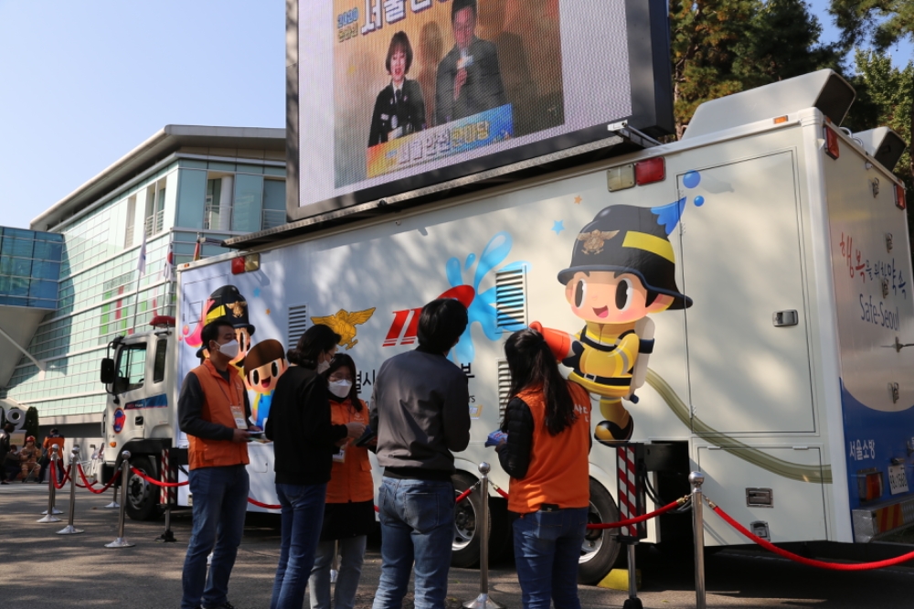 한화손해보험 봉사단이 30일 오후 동작구 보라매안전체험관 앞에서 시민들을 대상으로 온라인서울안전한마당행사를 위해 봉사활동을 하고 있다./사진=한화손해보험