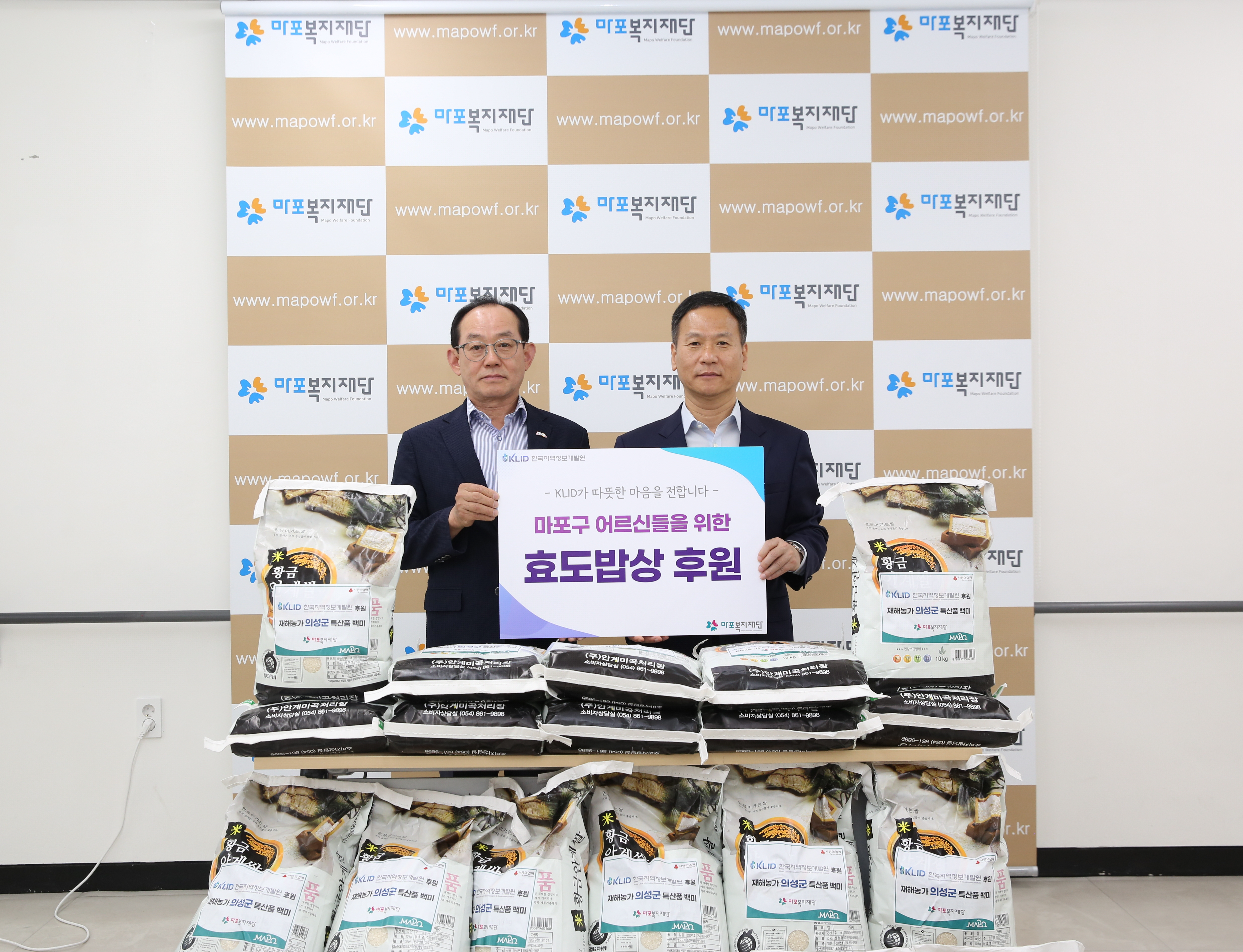 박덕수 한국지역정보개발원 원장(오른쪽)이 이홍주 마포복지재단 이사장과 마포 효도밥상식자재 기증식에서 기념촬영을 하는 모습./사진제공=한국지역정보개발원